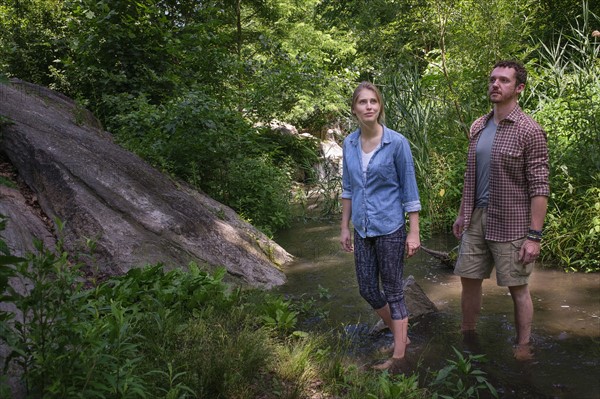 Couple wading in water.