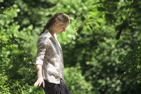 Woman balancing in forest.