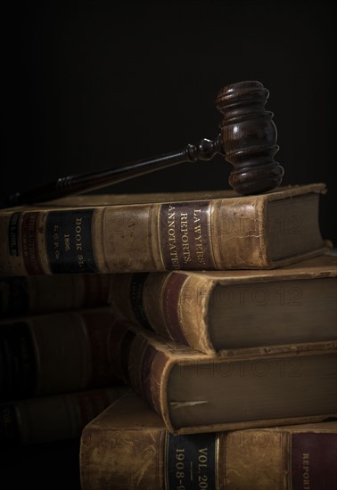 Wooden hammer on stack of books.