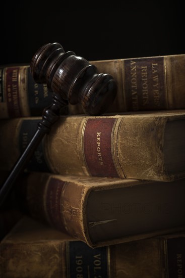 Wooden hammer and stack of books.