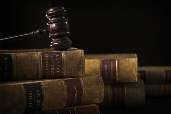 Wooden hammer on stack of books.