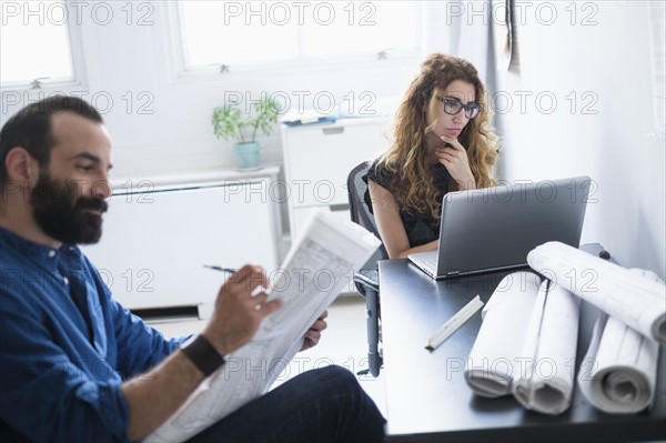 Man and woman working together in office.