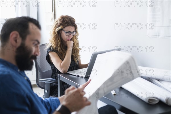 Man and woman working together in office.