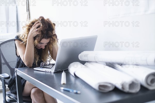 Upset woman in office.