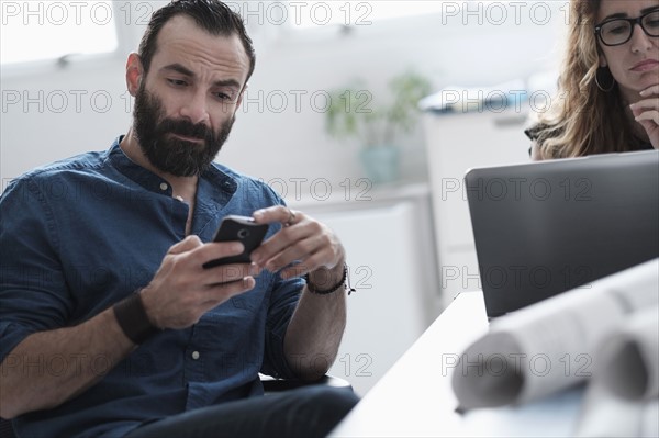 Man and woman working in office.