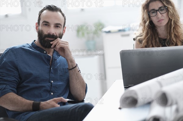 Man and woman talking in office.