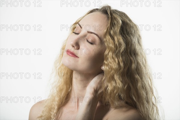 Portrait of beautiful woman with long, blond, curly hair.