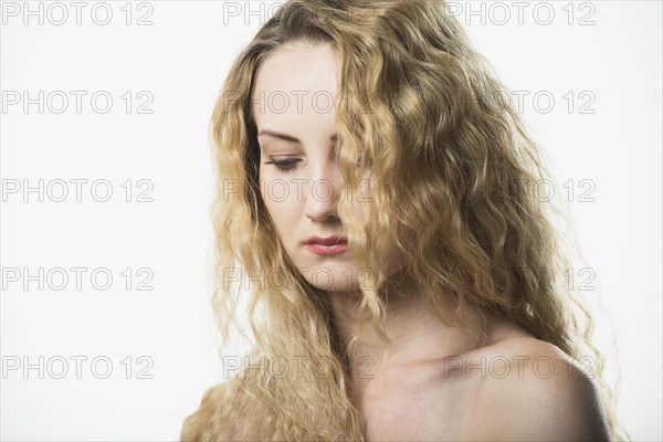 Portrait of beautiful woman with long, blond, curly hair.