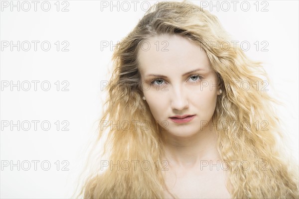 Portrait of beautiful woman with long, blond, curly hair.