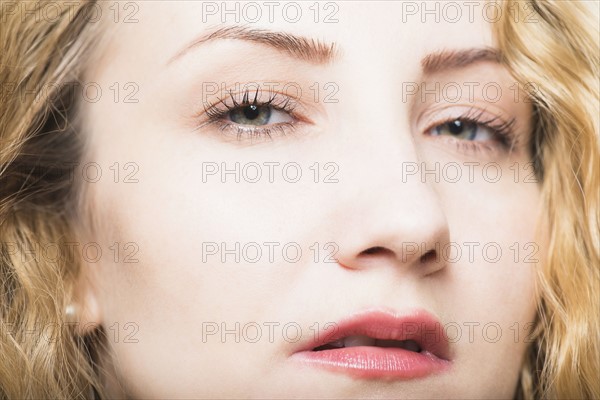 Portrait of beautiful woman with long, blond, curly hair.