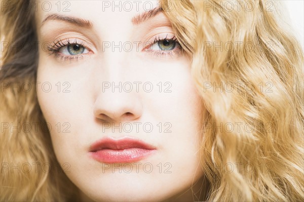 Portrait of beautiful woman with long, blond, curly hair.