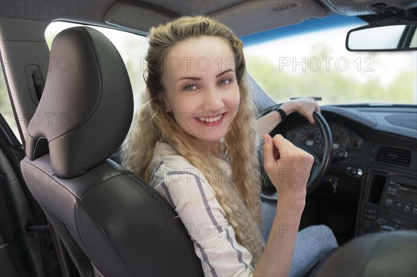 Portrait of woman sitting in car.