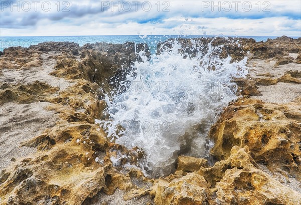 Wave splashing on rock formation