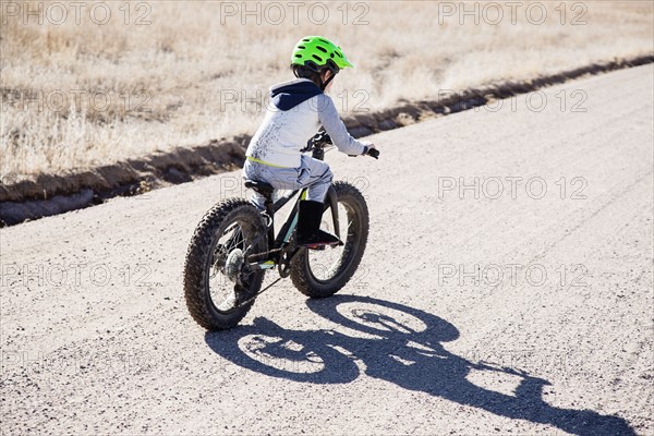 Boy (6-7) riding bicycle