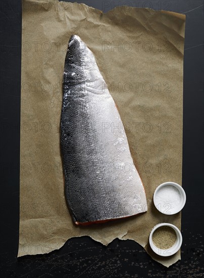 Fresh fillet of raw salmon on brown paper