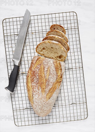 Overhead view of loaf of rye bread and knife