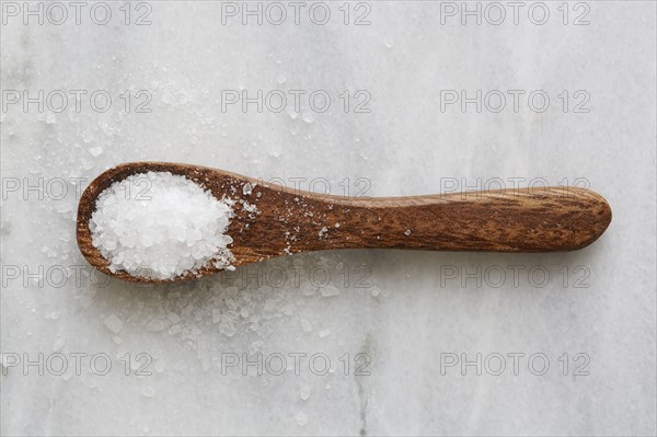 Overhead view of wooden spoon with sea salt
