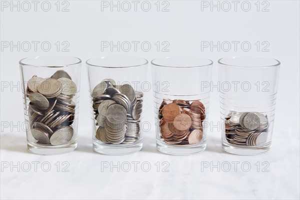 Row of glasses with coins