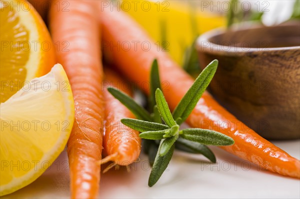 Carrots and oranges with fresh herb
