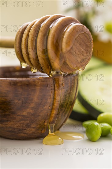 Honey dipper on bowl with honey