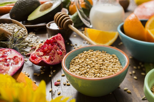 Wheat seeds in bowl and fresh fruits