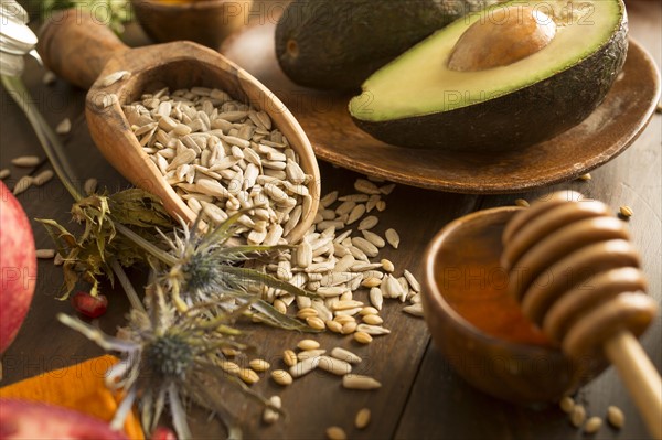 Wheat seeds, avocado and honey with dipper