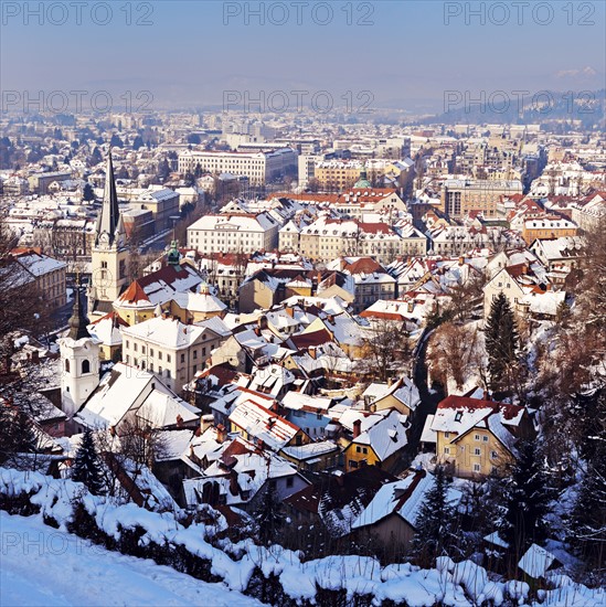 Slovenia, Ljubljana, Snowy city at sunset