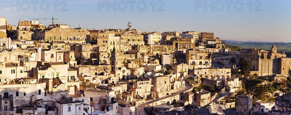 Italy, Basilicata, Matera, Panorama of old town at sunset