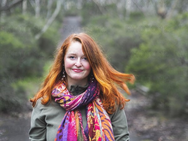 Portrait of smiling redhead woman in scarf