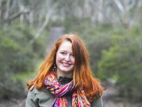 Portrait of smiling redhead woman in scarf