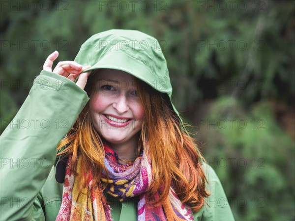 Portrait of smiling redhead in green jacket