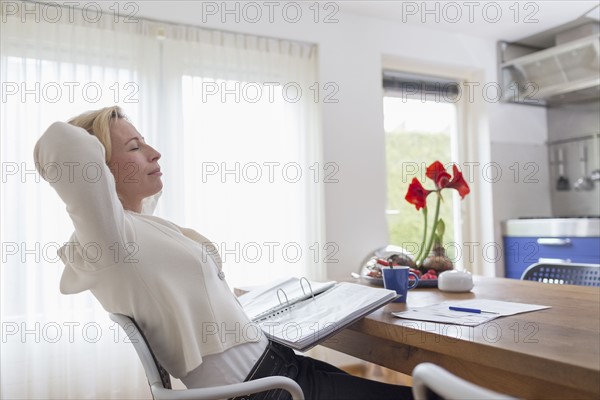 Woman taking break from paperwork