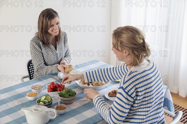 Women at laid table in dining room