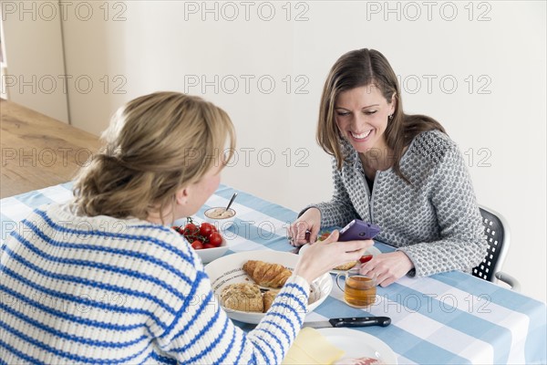 Women at laid table in dining room