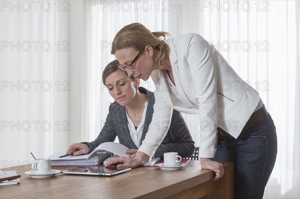 Businesswomen analyzing documents