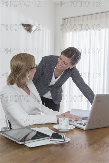 Discussion between businesswomen at work