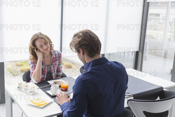 Mid-adult couple at breakfast table