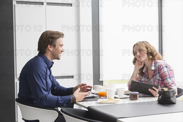 Mid-adult couple at breakfast table