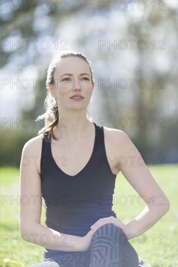 Mid-adult woman exercising in park