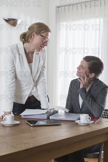 Businesswomen chatting at office