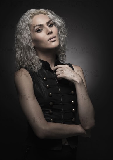 Studio portrait of young woman with white hair.