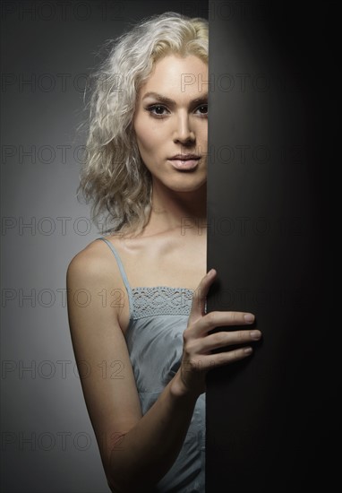 Studio portrait of young woman with white hair.