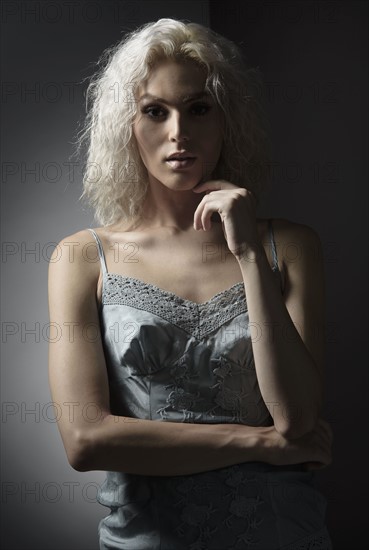 Studio portrait of young woman with white hair.