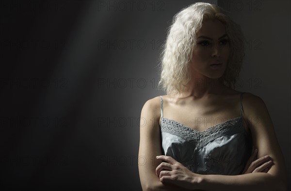 Studio portrait of young woman with white hair.