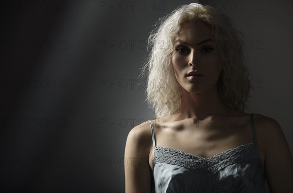 Studio portrait of young woman with white hair.