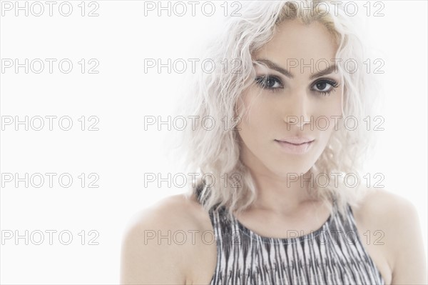 Studio portrait of young woman with white hair.