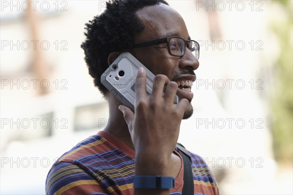 Mid adult man talking on phone.