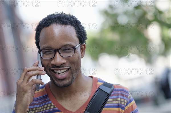 Mid adult man talking on phone.