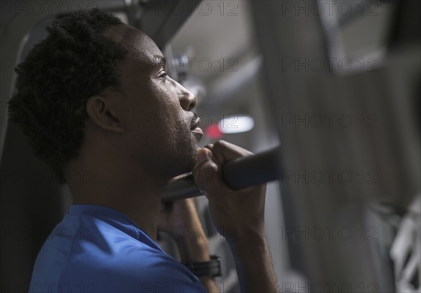 Mid adult man working out in gym.