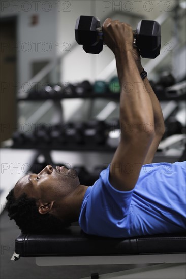 Mid adult man working out in gym.